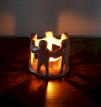 Five figures linking arms around a central light